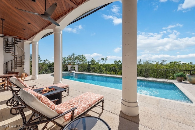 view of swimming pool with a patio and ceiling fan