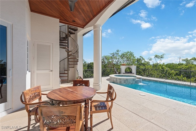 view of pool featuring a patio area, ceiling fan, and an in ground hot tub