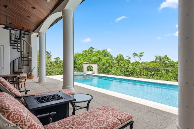 view of pool featuring a patio and a fire pit