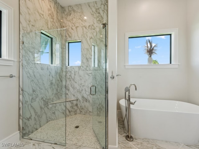 bathroom featuring separate shower and tub