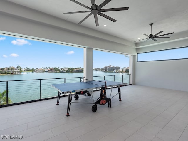 view of patio / terrace with a balcony, a water view, and ceiling fan