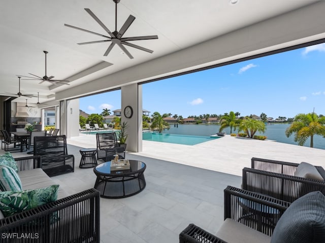 view of patio with ceiling fan, outdoor lounge area, and a water view