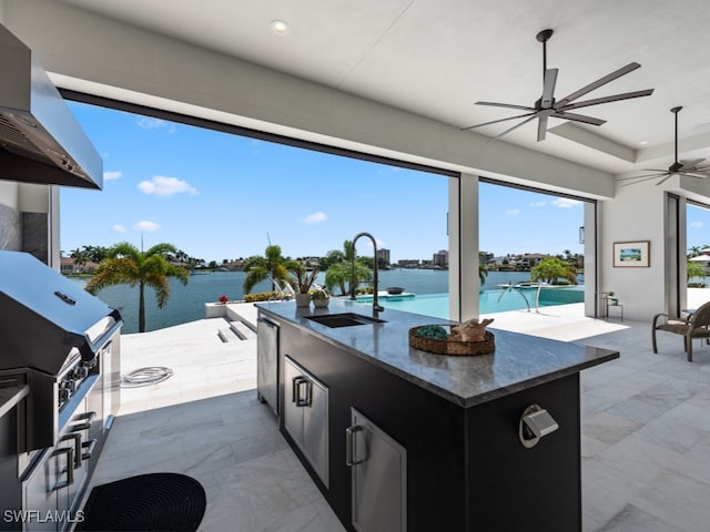 view of patio / terrace featuring sink, a water view, area for grilling, ceiling fan, and grilling area