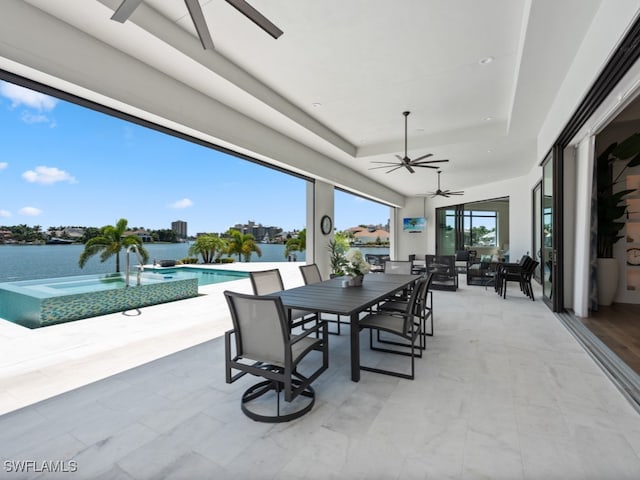 view of patio / terrace with a water view and ceiling fan