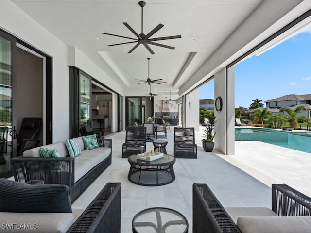 view of patio with an outdoor living space and ceiling fan