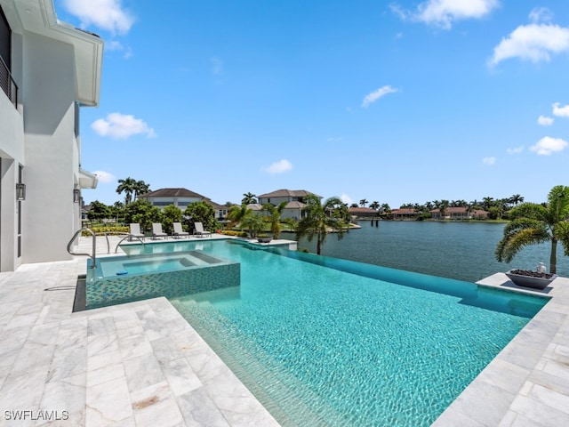 view of swimming pool with a patio, an in ground hot tub, and a water view