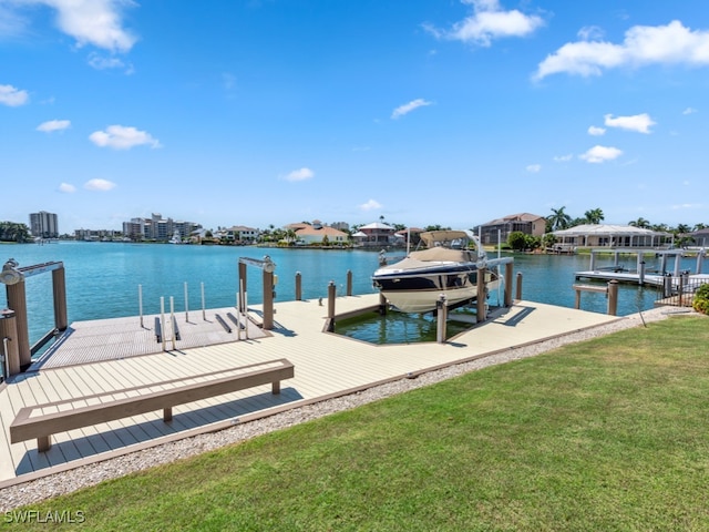 view of dock featuring a water view and a yard