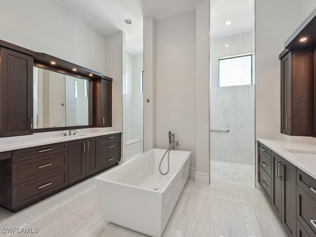 bathroom with tile patterned flooring, vanity, and plus walk in shower