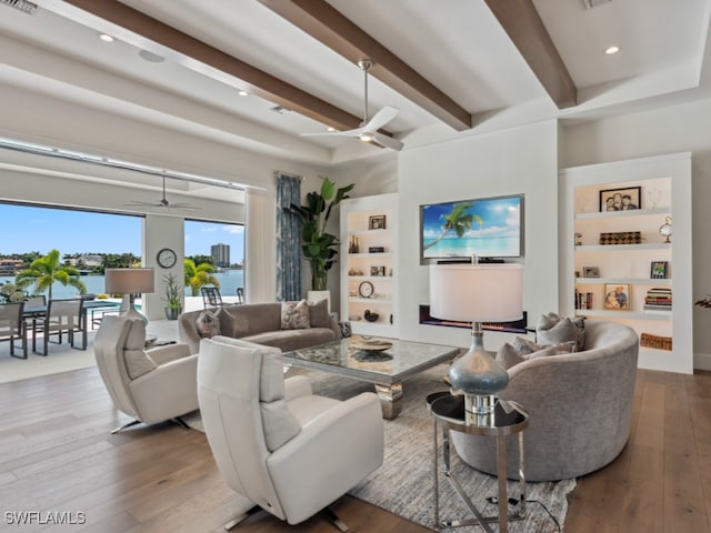 living room with beam ceiling, ceiling fan, and hardwood / wood-style flooring