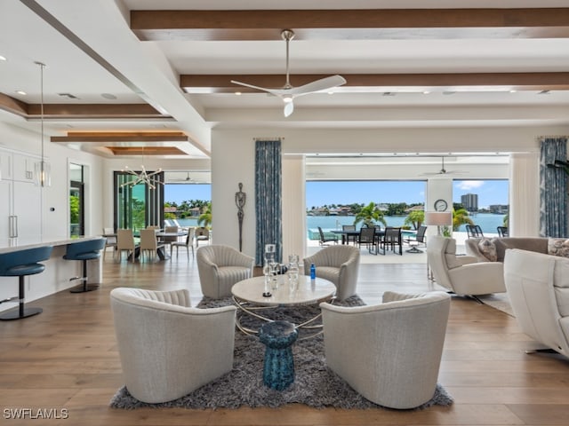 dining room featuring light wood-type flooring, a healthy amount of sunlight, beamed ceiling, and ceiling fan