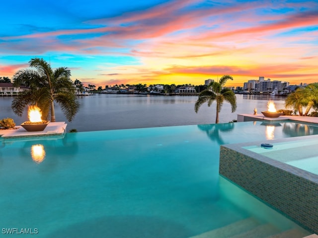 pool at dusk with a water view