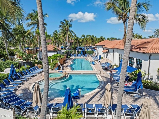 view of swimming pool with a patio and a community hot tub