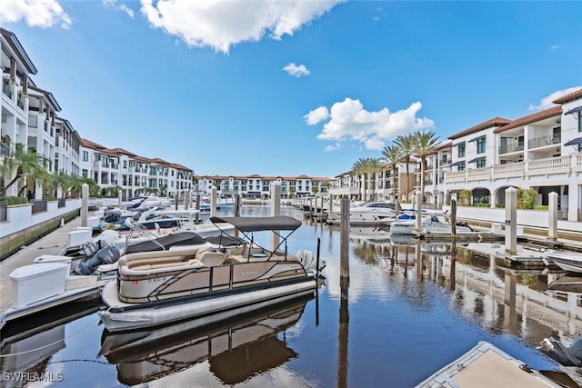 view of dock with a water view and a residential view