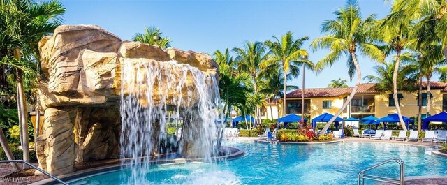 view of swimming pool with pool water feature