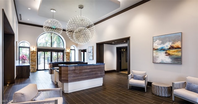 welcome area featuring a chandelier and french doors