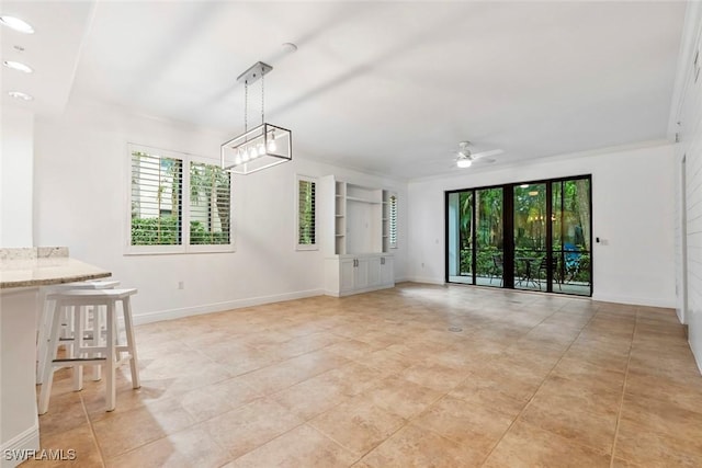 interior space featuring crown molding, light tile patterned floors, and ceiling fan