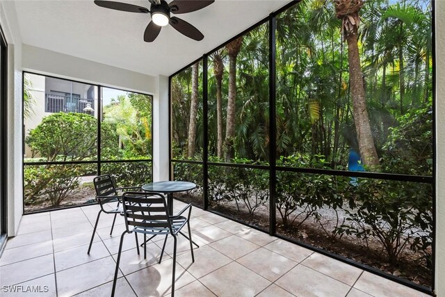 unfurnished sunroom featuring a ceiling fan