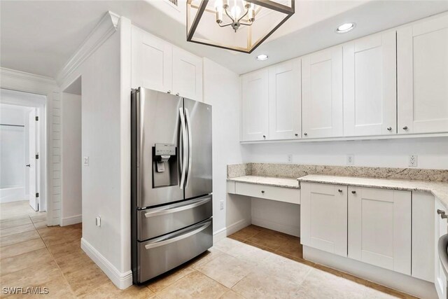 kitchen featuring white cabinetry, stainless steel refrigerator with ice dispenser, and ornamental molding