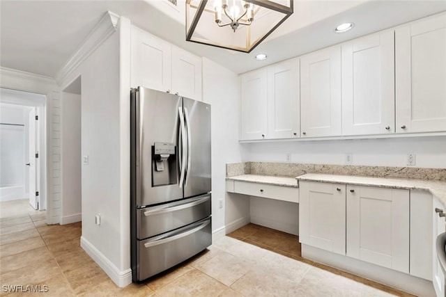 kitchen featuring stainless steel fridge, white cabinets, light stone countertops, light tile patterned flooring, and recessed lighting