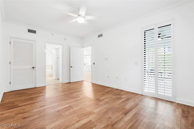 unfurnished bedroom with ornamental molding, visible vents, and light wood-style floors