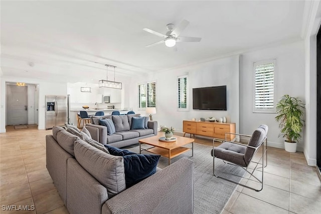 1035 Sandpiper St Unit F101, Naples, FL 34102 - living room featuring light tile patterned floors, baseboards, and ceiling fan