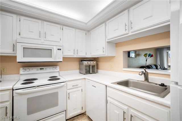 kitchen featuring white appliances, white cabinetry, and sink