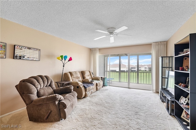 carpeted living room with a textured ceiling and ceiling fan