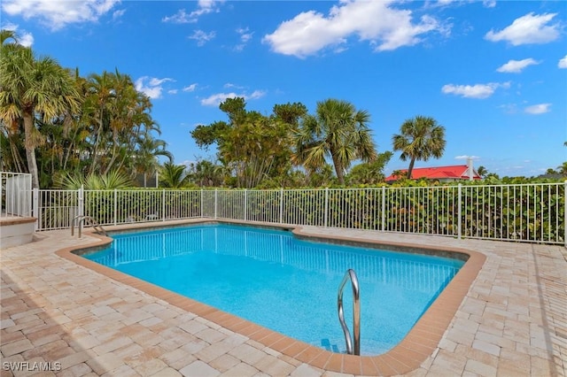 view of swimming pool with a patio area