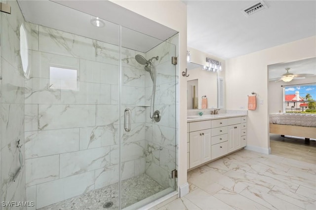 bathroom featuring ceiling fan, a shower with door, and vanity