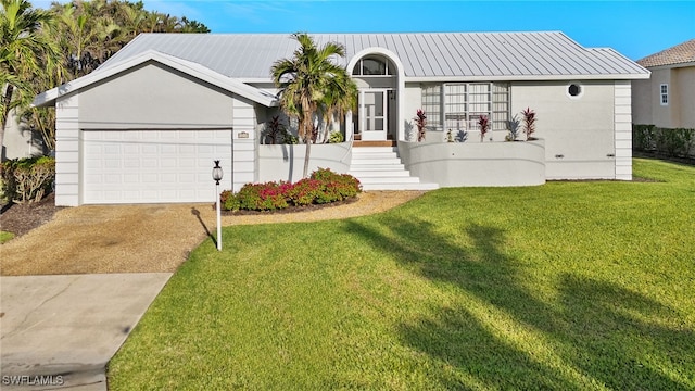 view of front of house featuring a front yard and a garage