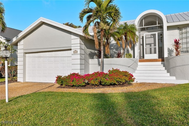 single story home featuring a front yard and a garage