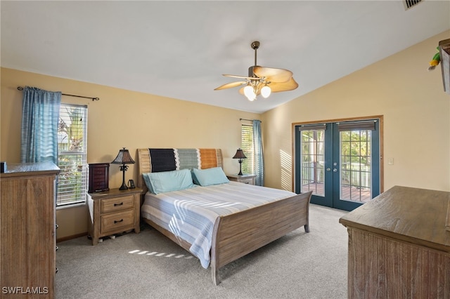 10610 Habitat Trl, Bokeelia, FL 33922 - bedroom featuring french doors, light carpet, access to outside, multiple windows, and vaulted ceiling