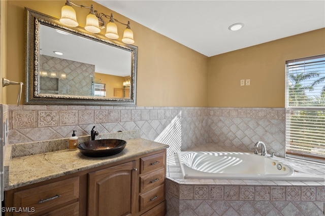 bathroom featuring vanity and tiled bath