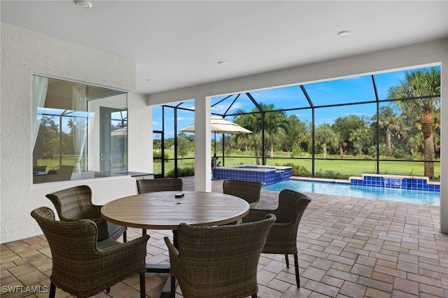 view of patio / terrace featuring a lanai, pool water feature, and a pool with hot tub