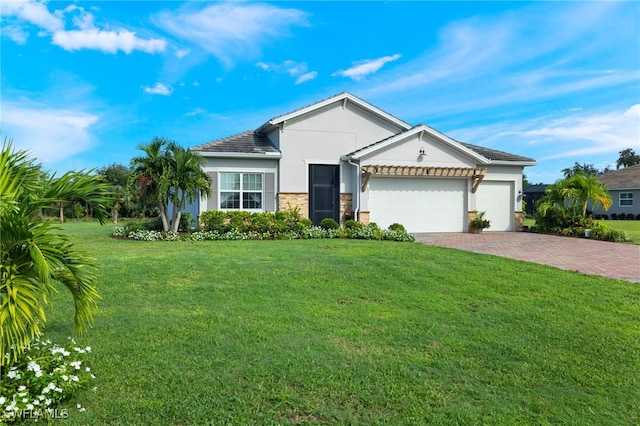 view of front of property with a front yard and a garage