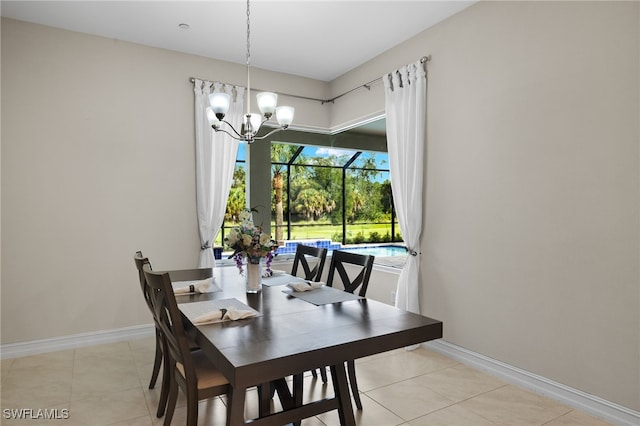 tiled dining room with an inviting chandelier