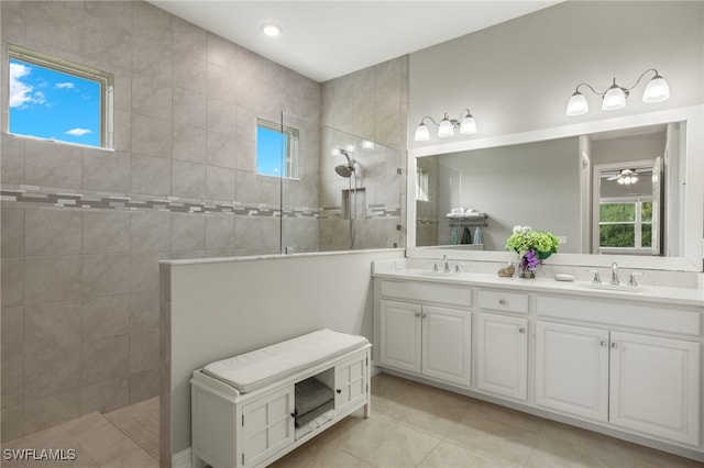 bathroom featuring tiled shower, vanity, ceiling fan, and tile patterned flooring