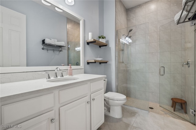 bathroom with tile patterned floors, an enclosed shower, vanity, and toilet