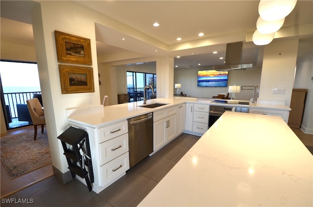 kitchen with light stone counters, sink, kitchen peninsula, white cabinetry, and stainless steel appliances