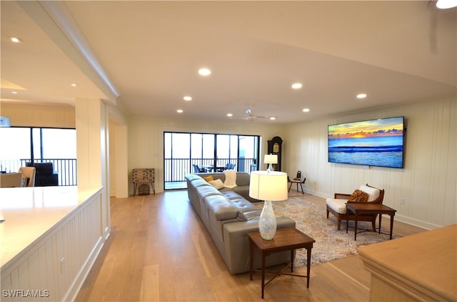 living room featuring light hardwood / wood-style floors and ceiling fan