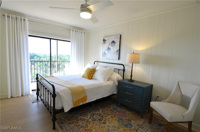 bedroom with access to outside, hardwood / wood-style flooring, crown molding, and ceiling fan