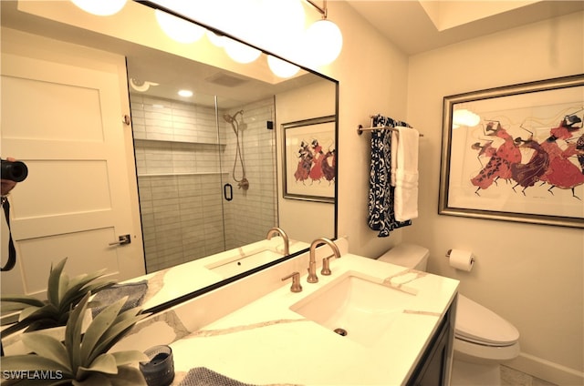 bathroom featuring vanity, toilet, and an enclosed shower