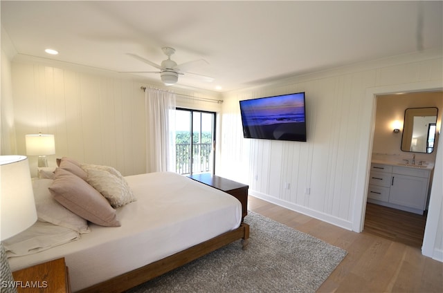 bedroom featuring ceiling fan, access to outside, sink, hardwood / wood-style floors, and ensuite bathroom