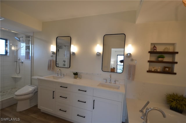 bathroom featuring walk in shower, hardwood / wood-style floors, vanity, and toilet