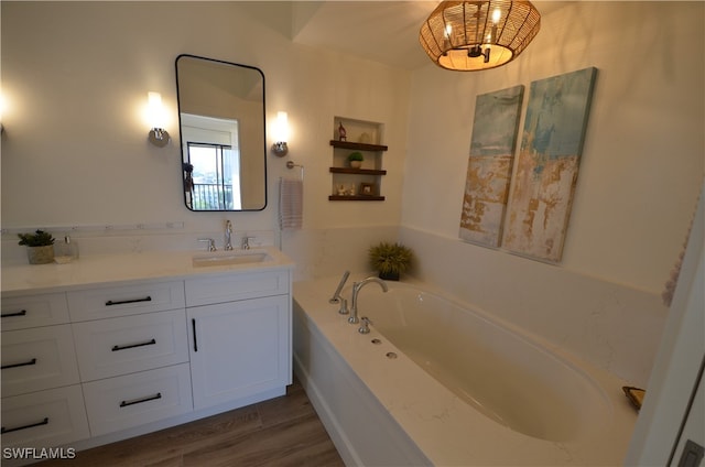 bathroom with wood-type flooring, vanity, and a bathing tub