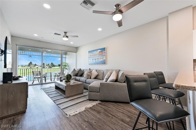 living room featuring ceiling fan and wood-type flooring