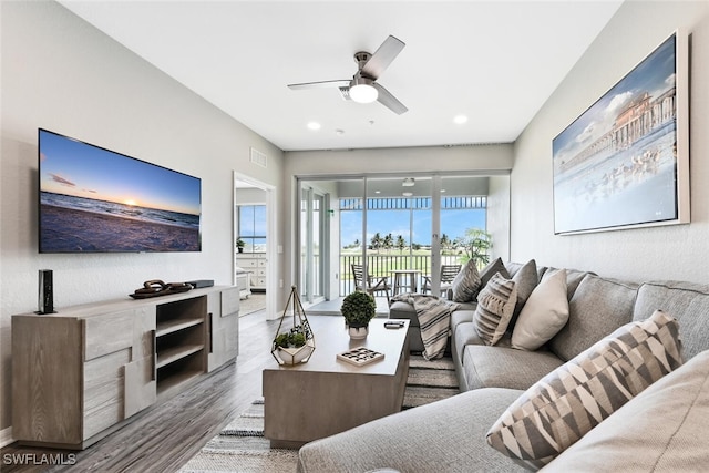 living room featuring light wood-type flooring and ceiling fan