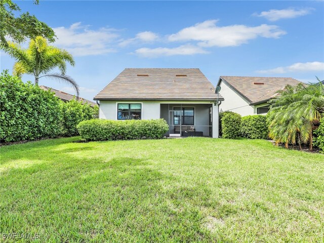 rear view of house with a yard