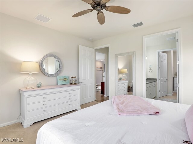 bedroom featuring ensuite bathroom, ceiling fan, and light colored carpet