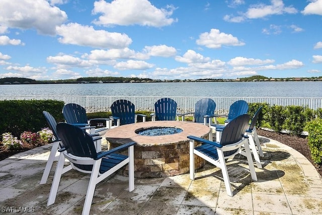 view of patio with a water view and an outdoor fire pit